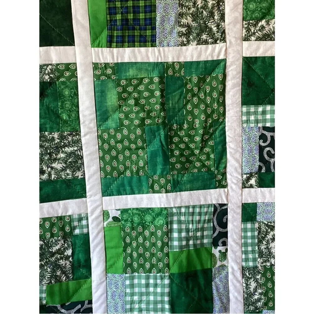 New without tags. Medley of Green Fabrics with White Borders Quilt